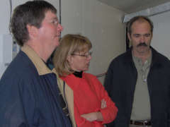 Mike Collins and Elaine Robichaud learn about the operation hub of the 7.4M dish from Dan Pellerin