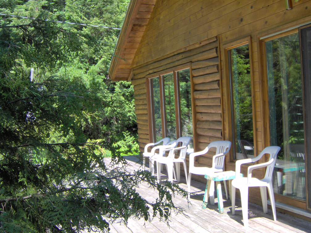 The side porch with the windows that are in the living and dining rooms