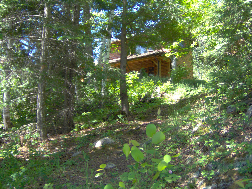 The house from the shore showing the trail up to front lawn