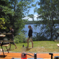 Leilani and Serena walking on the front lawn from inside the house through the kitchen window