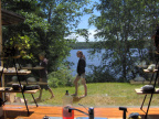 Leilani and Serena walking on the front lawn from inside the house through the kitchen window