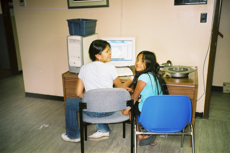 Young community members using computer at Kejick Bay band office