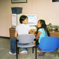 Young community members using computer at Kejick Bay band office