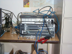 Closeup of the routing equipment.
The Cisco 2621 is configured to provide a simulated T1 frame-relay connection to the uBR7223.