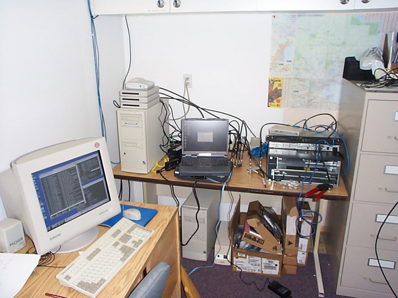 A DOCSIS cable plant on one table. The Cable Network Registration server is to the left with a number of cable modems on top.
I