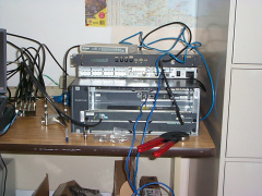 Closeup of the routing equipment.
The Cisco 2621 is configured to provide a simulated T1 frame-relay connection to the uBR7223.