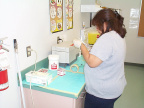 And here she is packing the sterilized equipment. Getting it all ready for use.
