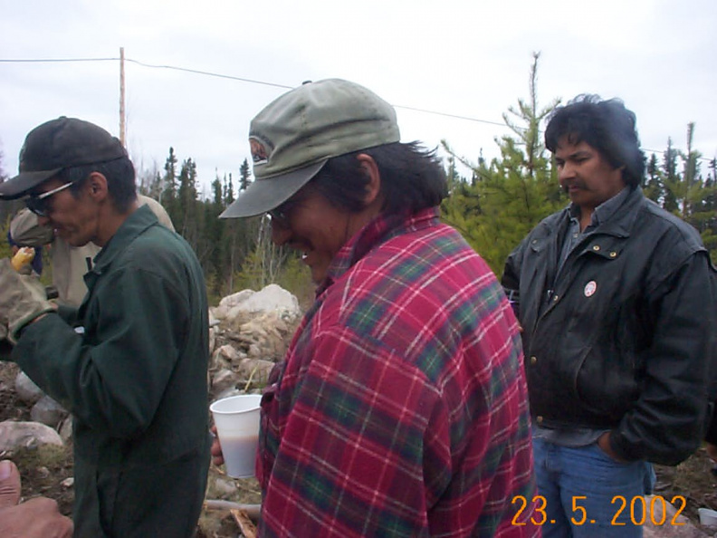 Marvin Meekis, Roland Pemmican and Bruce Rae looking at all that food