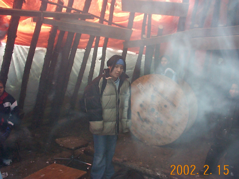 Annie Meekis warming up in the teepee at Little Bear's Beach.