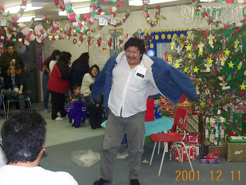 Johnny Meekis, Education Director, opens up his new jacket during the staff gift exchange.