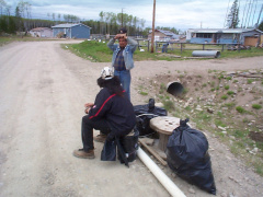 Dale Thompson and Barlow Kakegamic sitting down. Taking a break and waiting for the truck to haul away this garbage.
