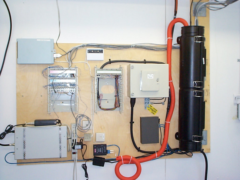 The splice enclosure mounted to the wall and fiber run to the transceiver for the wirless radio.