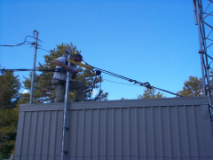 The telco mast was leaning due to the stress of all the fiber runs. A guy wire was installed to secure the mast.
