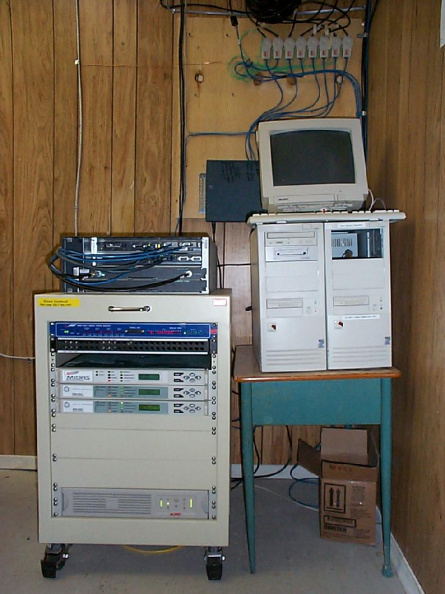 The satellite rack, uBR7223, cable registration server and DirecPC box (K-Net Router).