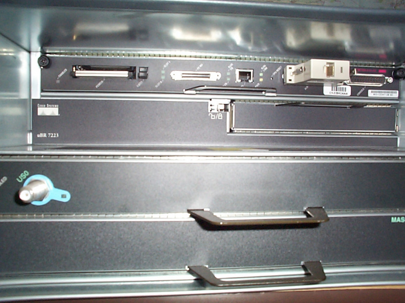 The port adapter slot is in the second row from the top and on the right hand side of the router. The locking latch needs to be moved to the left to release the panel. aac.jpg