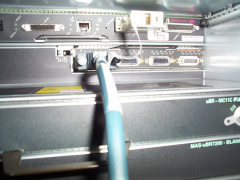 The other end of the cabe connected to port 0 of the port adapter card. The 2 screws on the cable should be tightened hand tight