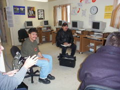 Alex Neveroff's hand, Gideon Kakepetum, and Stan Morris.