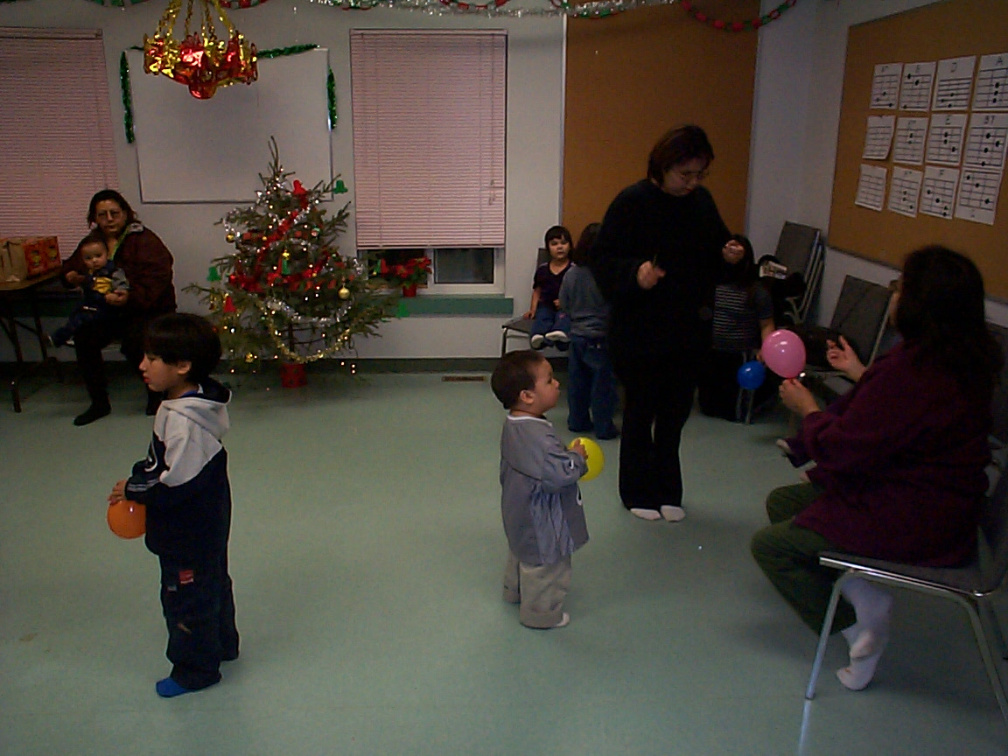 That's Karen Kakepetum standing there helping to put on some balloons on the kids leg.