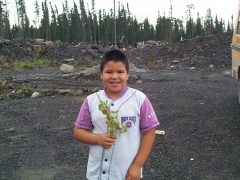 Here is Harriet Rae holding a Rasberry plant.