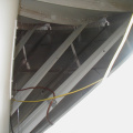 Between the dish and the insulated panel for the deicing system