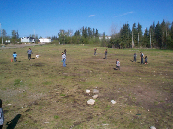 Kick-ball looks interesting from the sideline while watching the coach and the ref dule it out for who knows what.