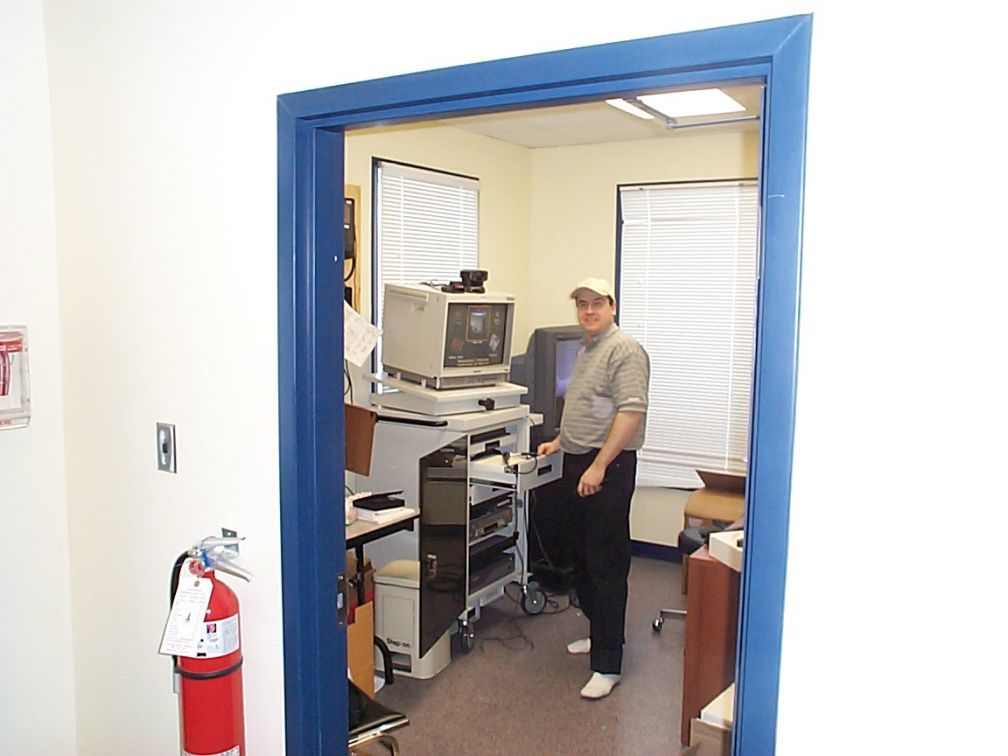 Technician from Toronto installing telehealth workstation at telehealth office in North Spirit.
