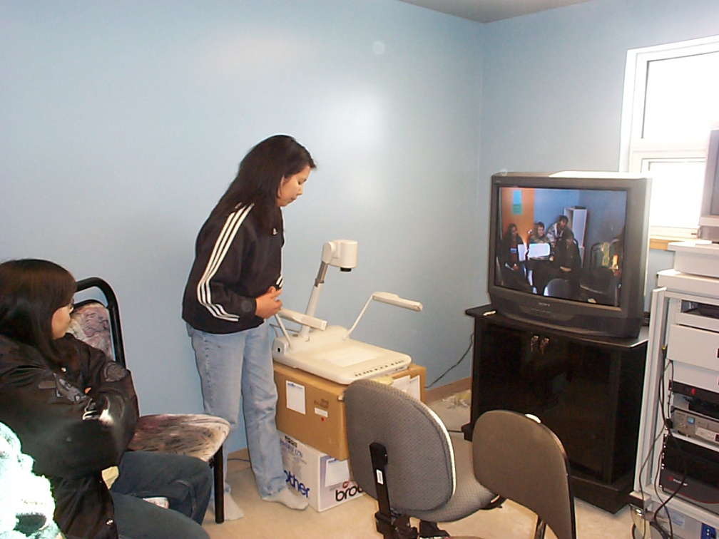 The telehealth coordinator is being trained via videoconference by an instructor in Toronto (see picture on monitor).