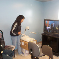 The telehealth coordinator is being trained via videoconference by an instructor in Toronto (see picture on monitor).