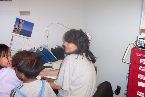 Here Is Kathleen checking up on a patient and on the left is Anita Kakegamic and Kyler Kakegamic