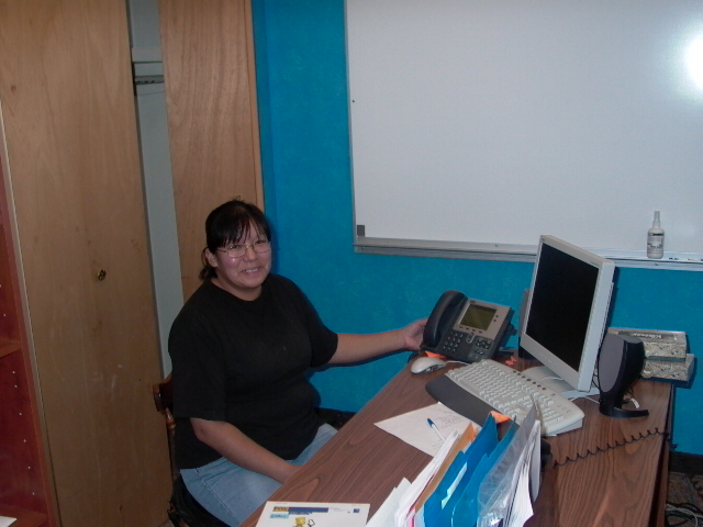 DL School Executive Secretary proudly displays her IP      phone.