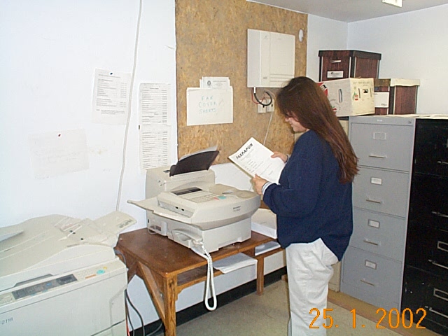 Karen Monias at the fax machine.