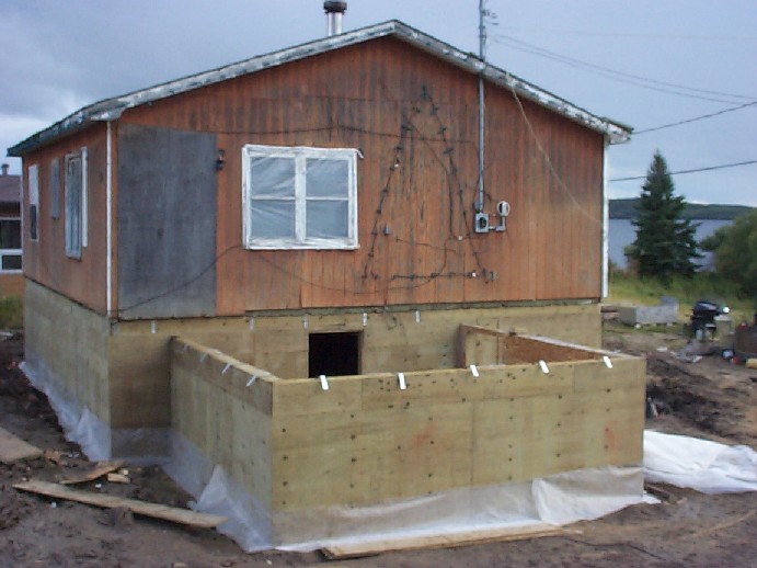 here is a picture of a house that's been raised and a room still under construction