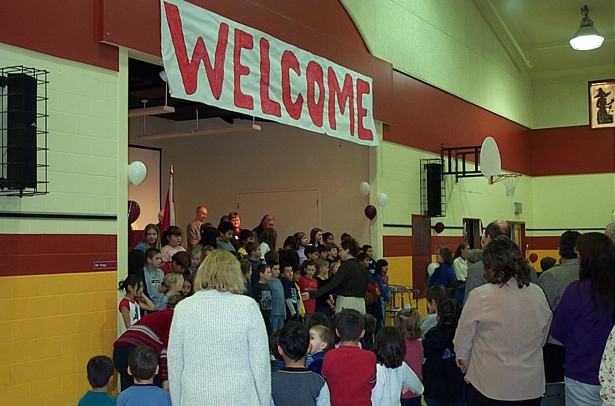 Students singing the bi-lingual National Anthem.